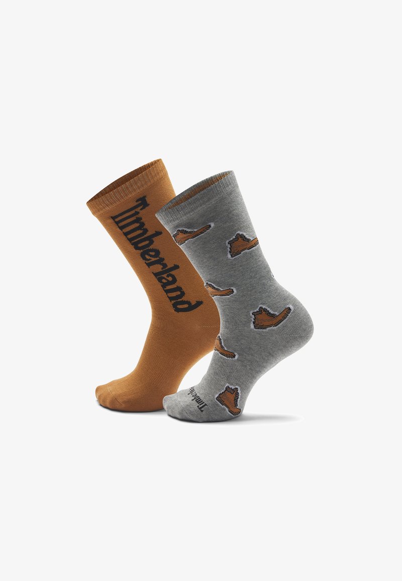 Due paia di calze: una arancio-marrone con il logo "Timberland", l'altra grigia con design di scarponi. Realizzate in cotone, presentano una superficie liscia.