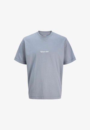 T-shirt en coton gris clair avec un col rond, des manches courtes et le texte brodé "Originals Studio" sur la poitrine. Texture douce, coupe décontractée.