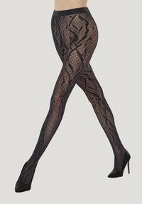 Schwarze gemusterte Strumpfhosen mit einem Gitter- und schlangenähnlichen Design, mit glatter Oberfläche und breitem Bund, getragen zu High Heels.