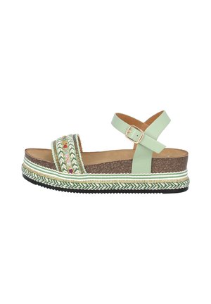 Platform sandals with a light green synthetic upper, braided pattern detailing, cork midsole, and black rubber outsole. Buckle strap closure.