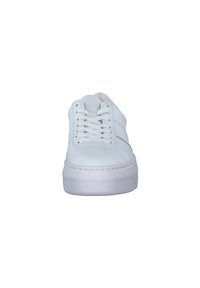 White leather sneaker with a rounded toe, textured rubber sole, flat laces, and minimalistic design featuring a subtle side stripe.