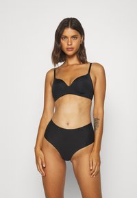 Black bikini set featuring a padded bralette with adjustable straps and high-waisted bottoms, made from smooth, stretchy fabric.