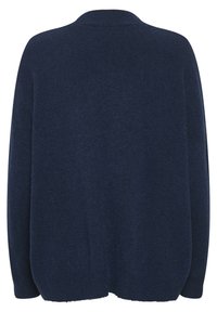 Mörkblå oversize-tröja med mjuk, texturerad stickning. Har en rundad halsringning och drop shoulder-design. Slät tyg, inga synliga mönster.