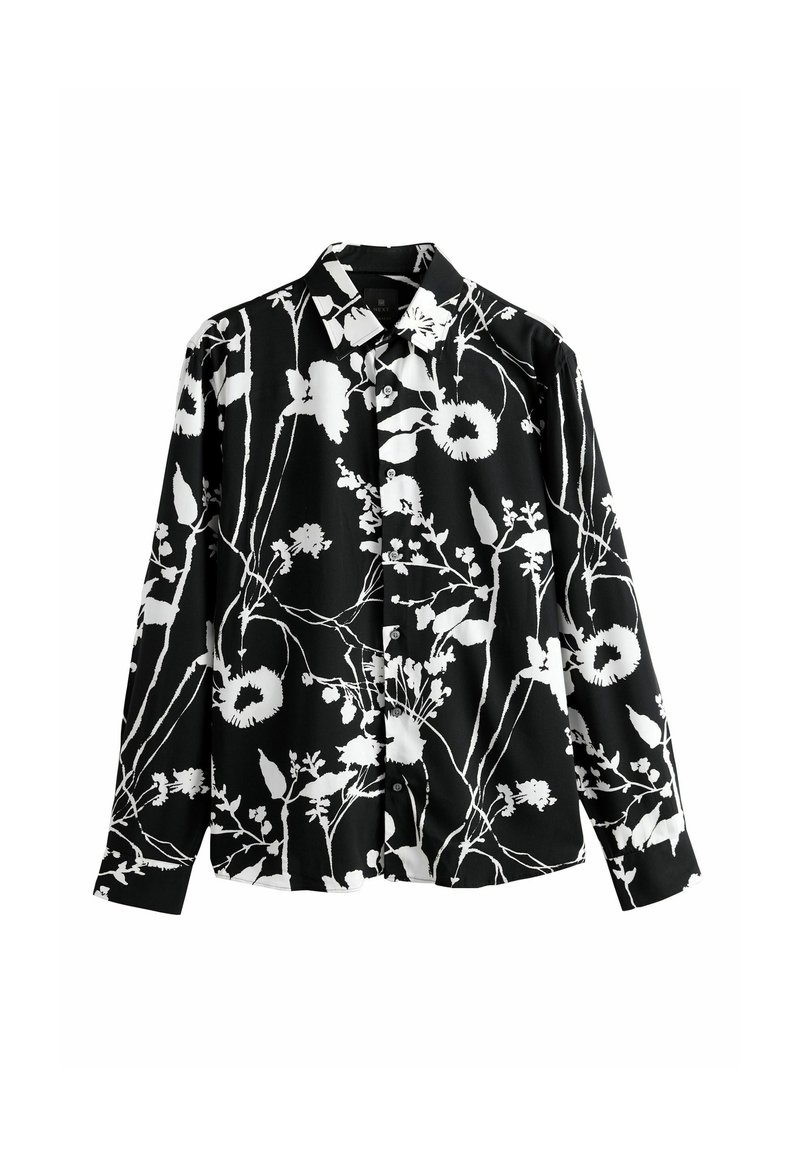 Fekete-fehér virágmintás, hosszú ujjú ing, galléros nyakkal, sima anyagból készült, laza szabású.