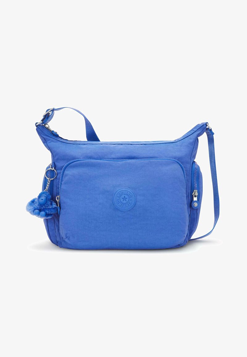 Borsa a spalla blu realizzata in morbido tessuto, con una tasca frontale con zip, tracolla e un piccolo portachiavi a forma di scimmietta blu come dettaglio.