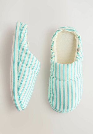 Striped blue and white slippers made of soft fabric with quilted design, featuring a fuzzy interior lining and a textured sole.