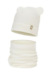 White knitted beanie with bear ears and a small heart tag. Matching white neck gaiter designed with a smooth, stretchy fabric.