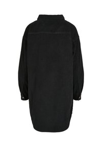 Longue robe-chemise en velours côtelé noir vue de dos avec manches longues et poignets boutonnés.