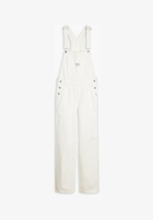 White cotton overalls with adjustable straps, front pockets, and silver hardware accents on sides. Smooth texture with a relaxed fit.