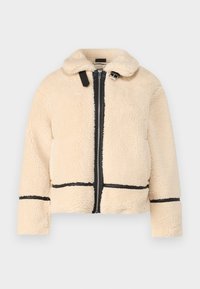 Kremfarget faux shearling-jakke med glidelås foran, svarte detaljer og krage. Har en avslappet passform og lange ermer.