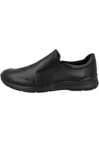 Schwarzer Slipper aus glattem Leder, mit elastischen Seitenpaneelen, runder Spitze und einer strukturierten Gummisohle für besseren Halt.