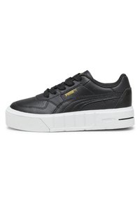 Black leather sneaker with a white textured platform sole, featuring a lace-up design and gold logo detail on the side.