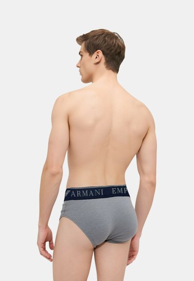 Boxer in cotone grigio con una vita elastica blu navy etichettata "Armani Emporio." Presentano un taglio classico e una texture liscia.