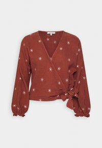 Rustfarbene Wickelbluse aus strukturiertem Stoff, mit langen, gepufften Ärmeln und weißer Blumenstickerei sowie einer gebundenen Vorderseite.