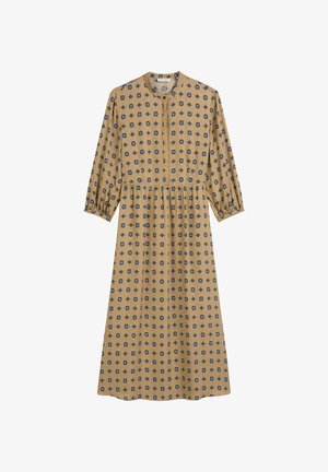 Langmouwige, mosterdkleurige jurk met een ronde halslijn en een geraffineerde taille, voorzien van een zwart geometrisch patroon door het geheel.