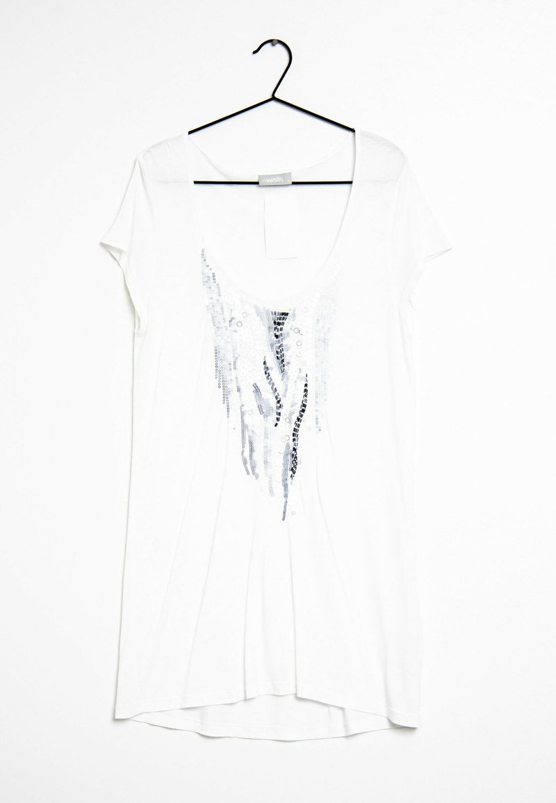 Vit t-shirt med kort ärm och rundad halsringning. Har en silverfärgad paljettdesign i ett vågigt mönster fram. Mjukt tyg.