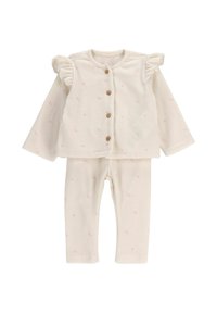 Kremowy strój dla niemowląt z długimi rękawami, brązowymi guzikami, falbaniastymi ramionami oraz małym różowym wzorem kropek, w komplecie ze spodniami.