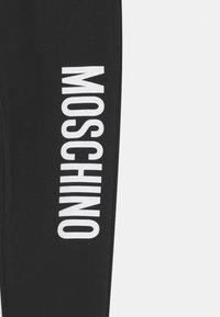 MOSCHINO UNISEX - Tracksuit bottoms - black