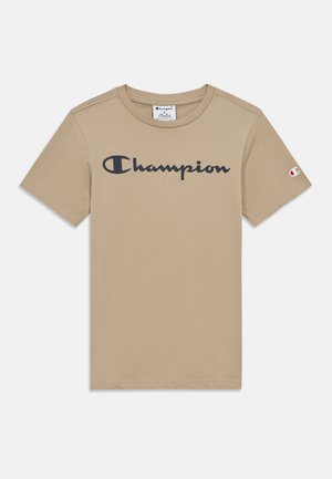 Beige katoenen T-shirt met een zwarte "Champion"-logo op de borst, standaard ronde hals en een klein logo-accent op de mouw.