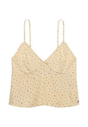 Top tipo camisola beige claro con tirantes finos ajustables, pequeño estampado floral azul, copas fruncidas y un pequeño lazo decorativo en el centro delantero.