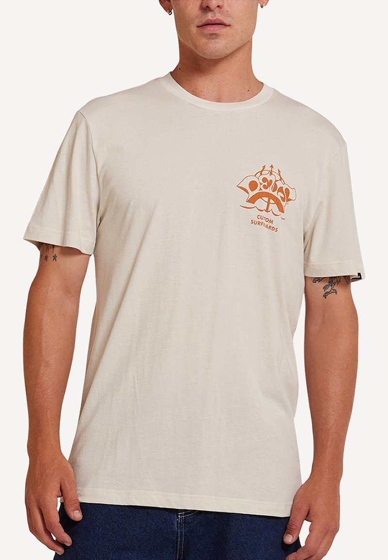 Beige cotton T-shirt featuring a left chest graphic in orange, short sleeves, and a crew neckline. Minimalist design with smooth texture.