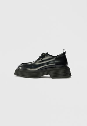 Schwarze Lackleder-Oxford-Schuhe mit runder Spitze, dicker gerippter Sohle, Schnürdesign und einem hinteren Zugband für einfaches An- und Ausziehen.