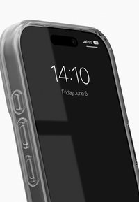 Klar telefonetui med et slankt design, markerede kanter og udskæringer til knapper. Enhedens skærm viser tid og dato.