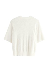 Kortærmet, hvid sweater i blødt, struktureret stof. Har en rund halsudskæring og en let løs pasform med let ribbede kanter.