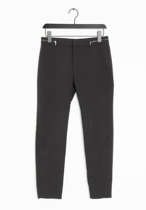 Pantalons noirs ajustés avec une texture lisse, dotés de deux zips à l'avant, de coutures verticales et d'une coupe fuselée.
