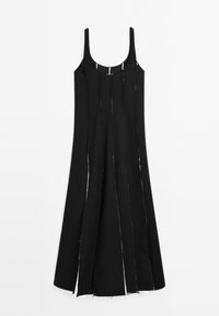 Black dress with thin shoulder straps, a straight cut, and vertical slits along the fabric, highlighting raw edges and texture.