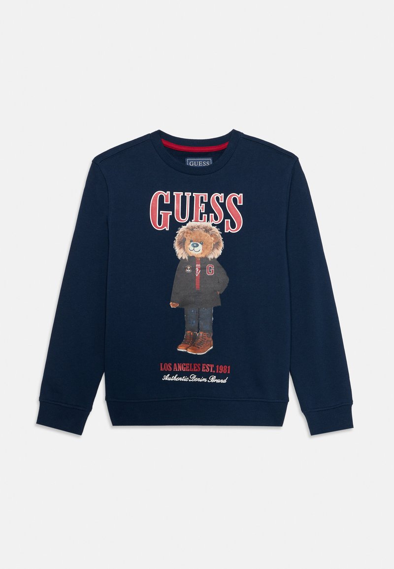 Felpa navy con grafica di un orso in abbigliamento invernale, con lettering rosso "GUESS" e testo sottostante. Collo rotondo e polsini a costine.
