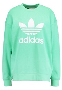 Mintgrön sweatshirt med vit Adidas-logotyp och tre ränder på framsidan. Tillverkad av mjukt material med ribbade ärmslut och fåll.