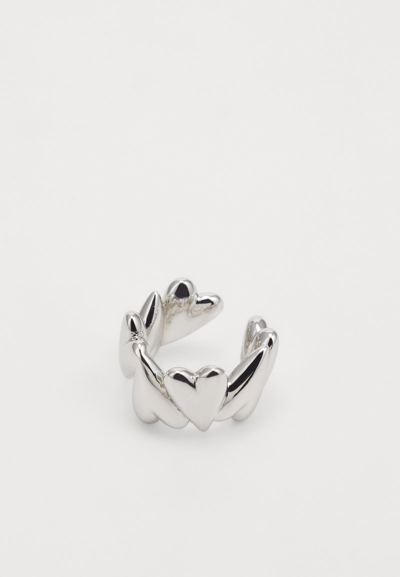 Silver ring featuring a heart-shaped design with a twisted band. Smooth, shiny surface with multiple heart accents along the band.