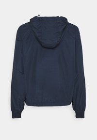 Navy blue hooded jacket with long sleeves and elastic cuffs, shown from the back on a white background.