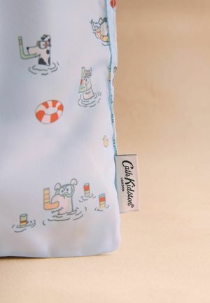 Light blue fabric with cartoon dogs wearing snorkels, floating objects, and a Cath Kidston London label on a beige background.