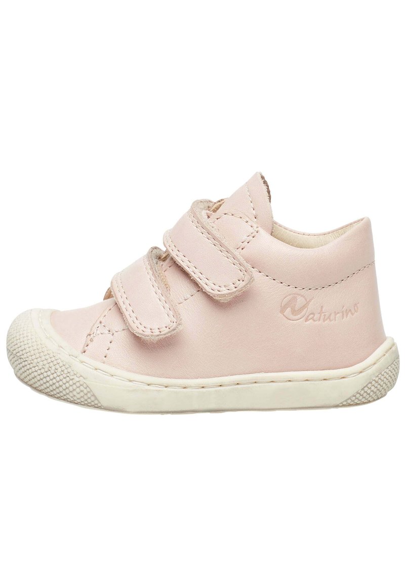Light pink leather shoe with two Velcro straps, rounded toe, and a white rubber sole featuring textured accents and branding on the side.