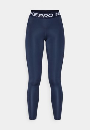 Leggings ajustés bleu marine avec une taille haute élastique portant "NIKE PRO" en texte blanc et un petit logo Nike swoosh blanc.