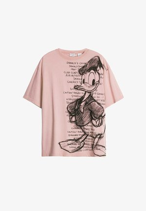 T-shirt en coton rose avec un grand croquis noir de Donald Duck et divers éléments textuels. Coupe ample, manches courtes et encolure ronde.
