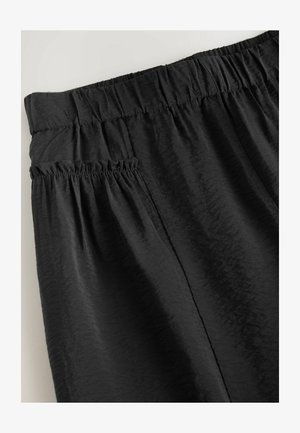 Crne hlače s elastičnom pasekom, koje imaju teksturiranu tkaninu i naborani detalj na bočnoj džepu. Glatka površina s suptilnim sjajem.