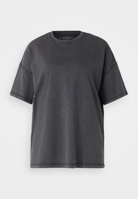 Übergroßes schwarzes Baumwoll-T-Shirt mit Rundhalsausschnitt, kurzen Ärmeln und sichtbaren Nähten an den Schultern und dem Saum.