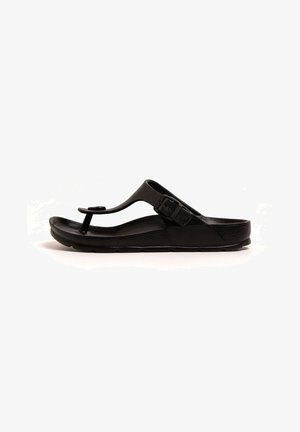 Black flip-flop sandal featuring a thong strap, textured footbed, adjustable buckle, and sporty design with a flat sole.