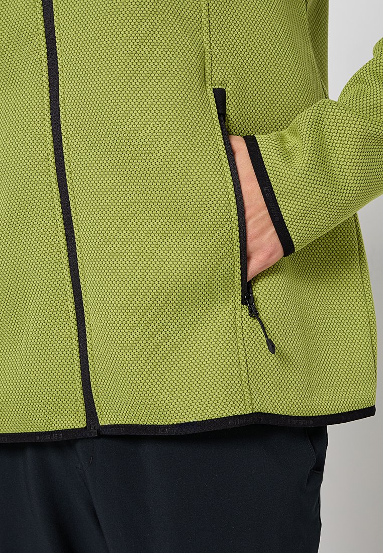 Grüne strukturierte Jacke mit schwarzem Reißverschlussdetail und Akzenten. Verfügt über eine seitliche Zippertasche und einen strukturierten Saum.