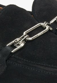 Czarne zamszowe buty z detalem w postaci srebrnego łańcuszka, o gładkiej fakturze i starannym przeszyciu wzdłuż krawędzi.