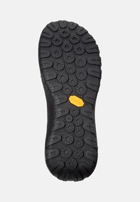Suola di scarpa in gomma nera con un motivo testurizzato composto da nodi circolari e un logo Vibram giallo. Taglia 38 indicata sul lato.