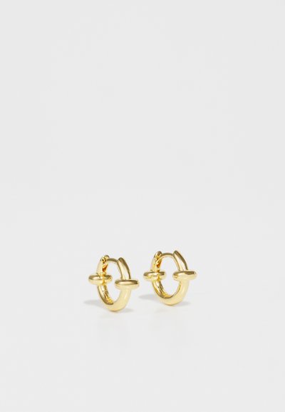 Gold hoop earrings featuring a smooth, shiny surface with a distinctive horizontal bar accent in the center. Compact and circular design.