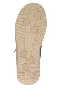 Suola in gomma beige con superficie testurizzata; motivi circolari e lineari per una migliore aderenza; colore chiaro in contrasto con la parte superiore scura.