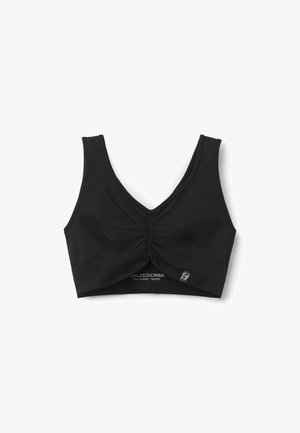 Bralette nera corta con scollatura a V, dettaglio arricciato al centro e spalline larghe. Realizzata in un tessuto morbido e elastico per garantire comfort.