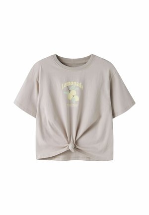 T-shirt beige clair à manches courtes avec nœud frontal, motif citron, et texte "Lemonade Vibes Only" sur la poitrine.