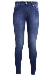 Hälsosamma blå denimjeans med medeltvätt, fem fickor, knapp- och dragkedjestängning samt diskreta stygnaccenter.