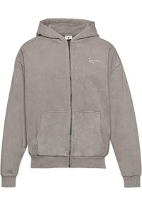 Gray cotton zip-up hoodie with a hood, front pockets, ribbed cuffs, and a small logo on the chest. Soft texture and oversized fit.